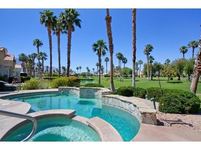 a view of a swimming pool and outdoor seating