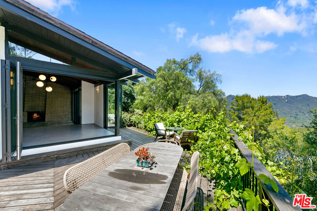 a view of a porch with furniture and a yard