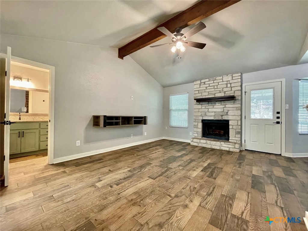 a view of empty room with a fireplace and fan