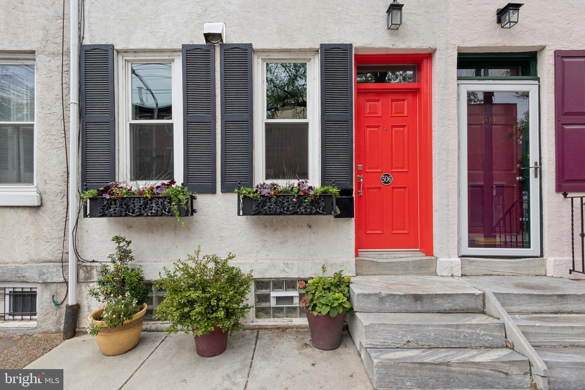 a front view of a building with potted plants