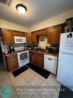 a kitchen with stainless steel appliances kitchen island granite countertop a sink and cabinets