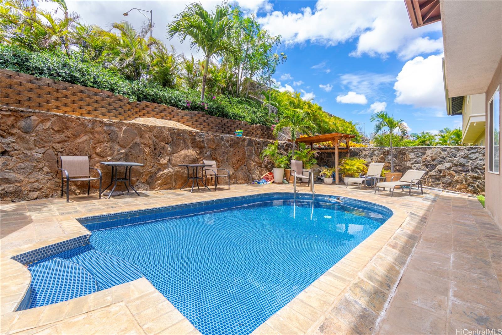 a view of swimming pool with outdoor seating and plants