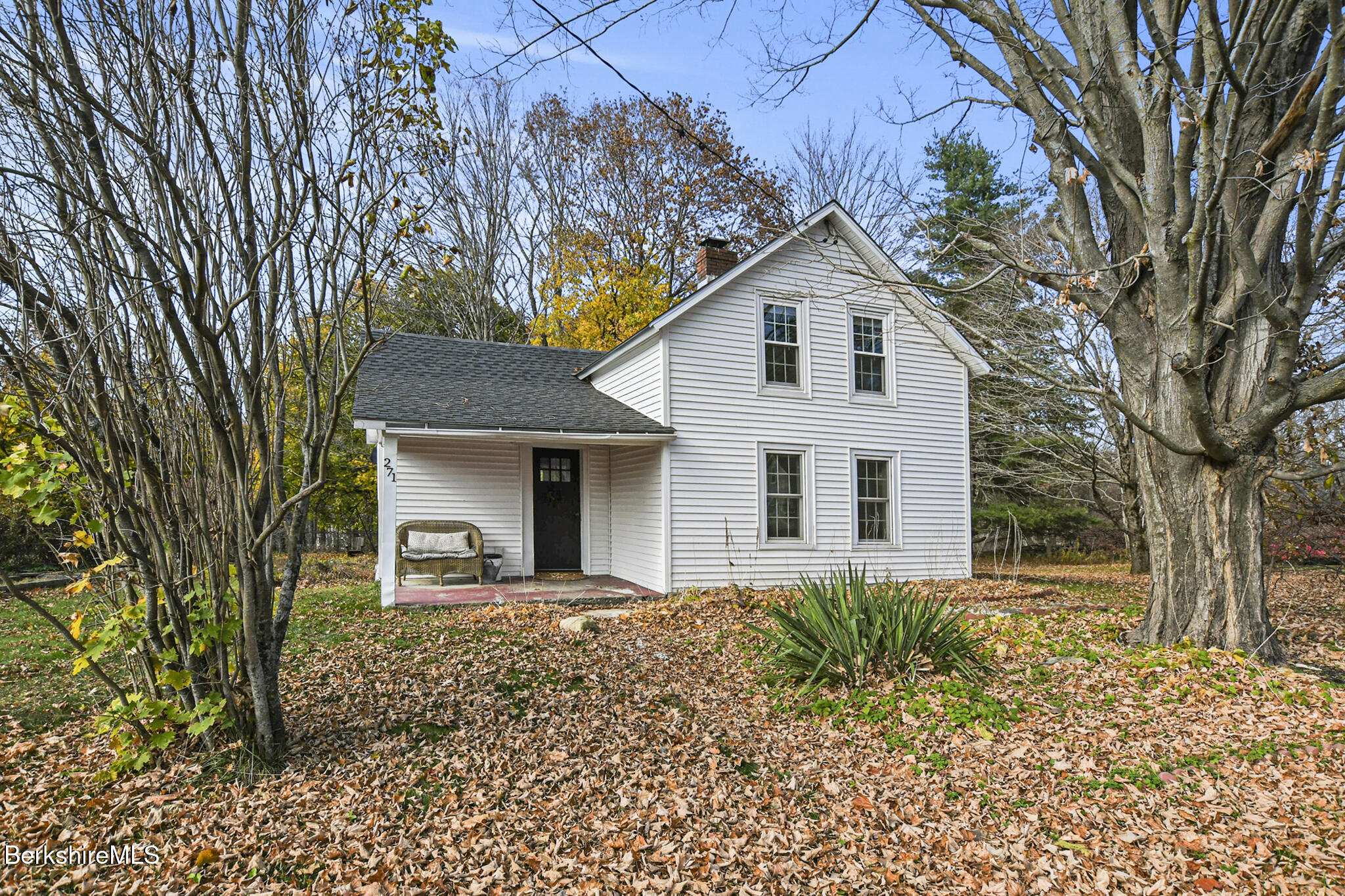 a front view of house with a garden