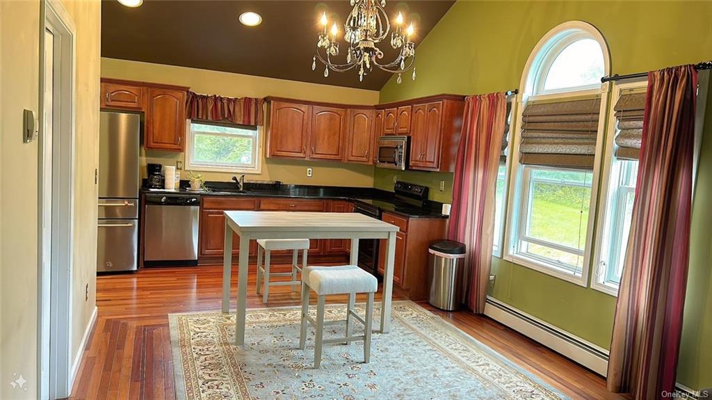 a kitchen with stainless steel appliances granite countertop a stove a refrigerator and a microwave