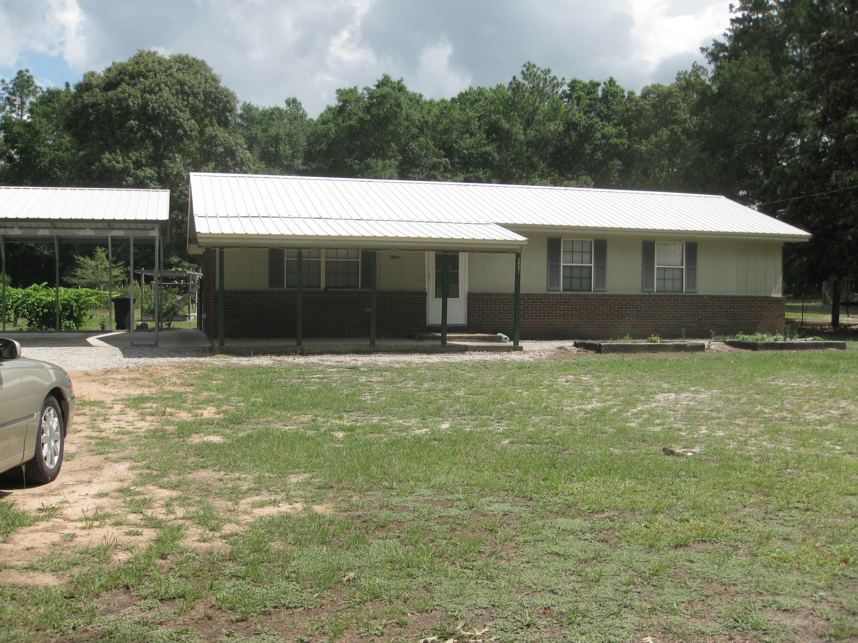 a view of a white house with a yard