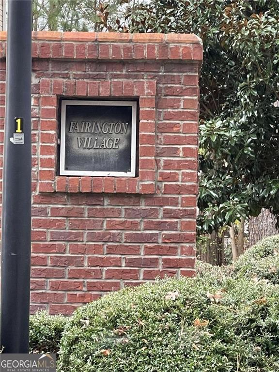 a brick building with a sign on it