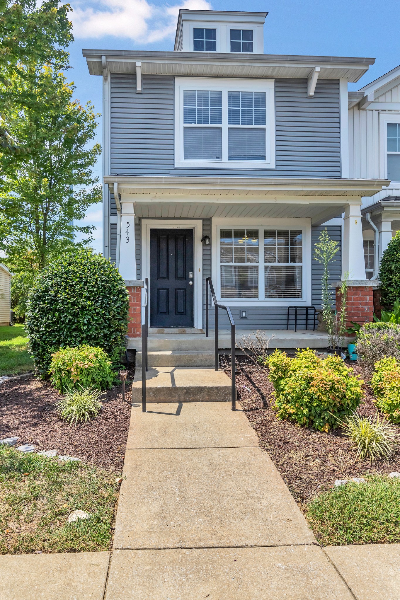 a front view of a house with garden