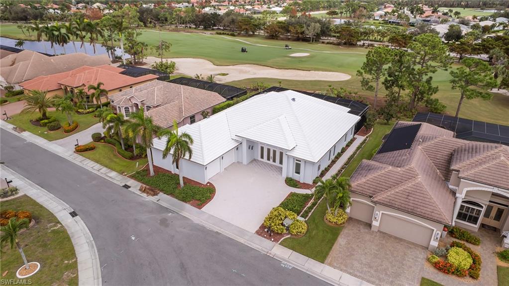 an aerial view of a house with garden space and lake view