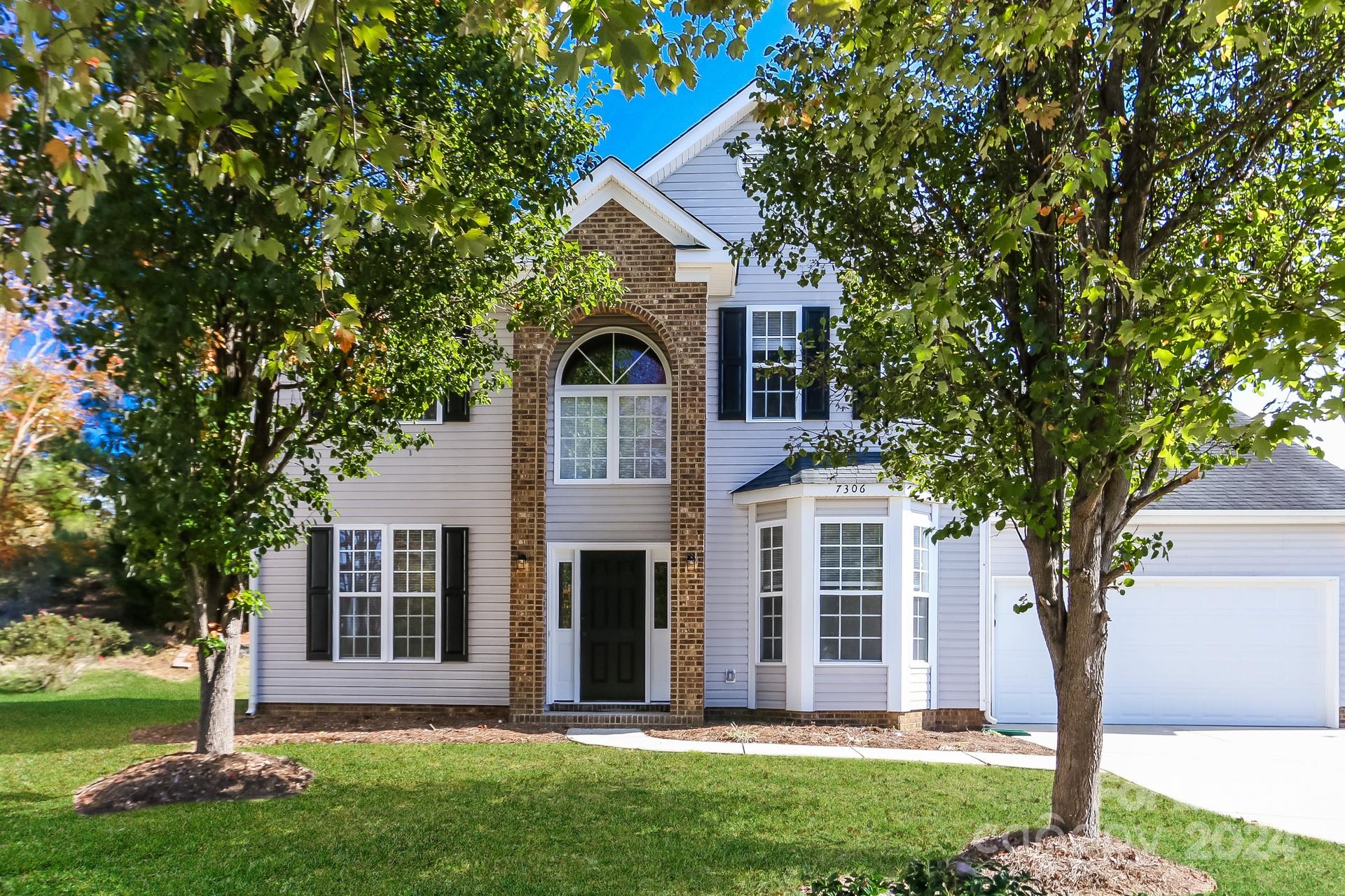 front view of a house with a yard