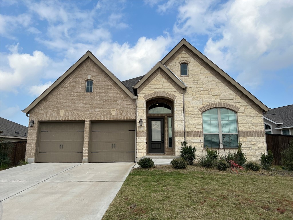 a front view of a house with a yard