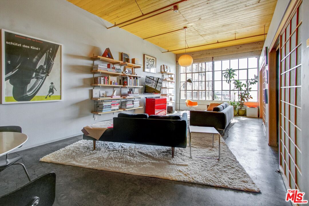 a living room with furniture rug and a window