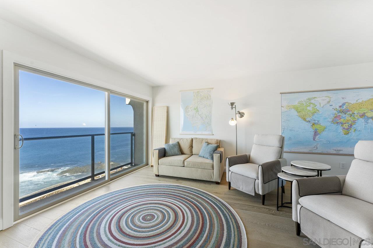 a living room with furniture and a floor to ceiling window