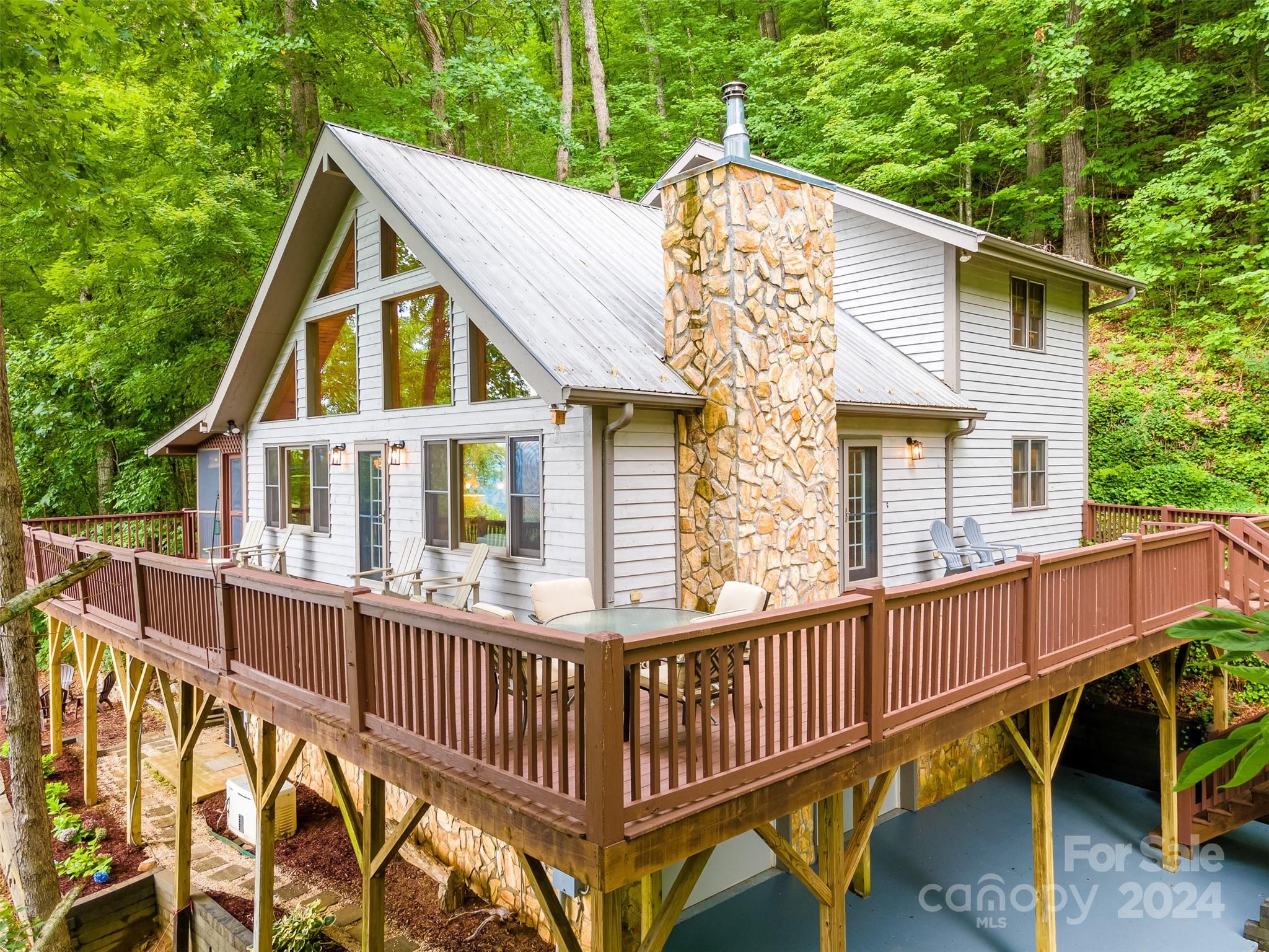 a view of a house with a yard and deck