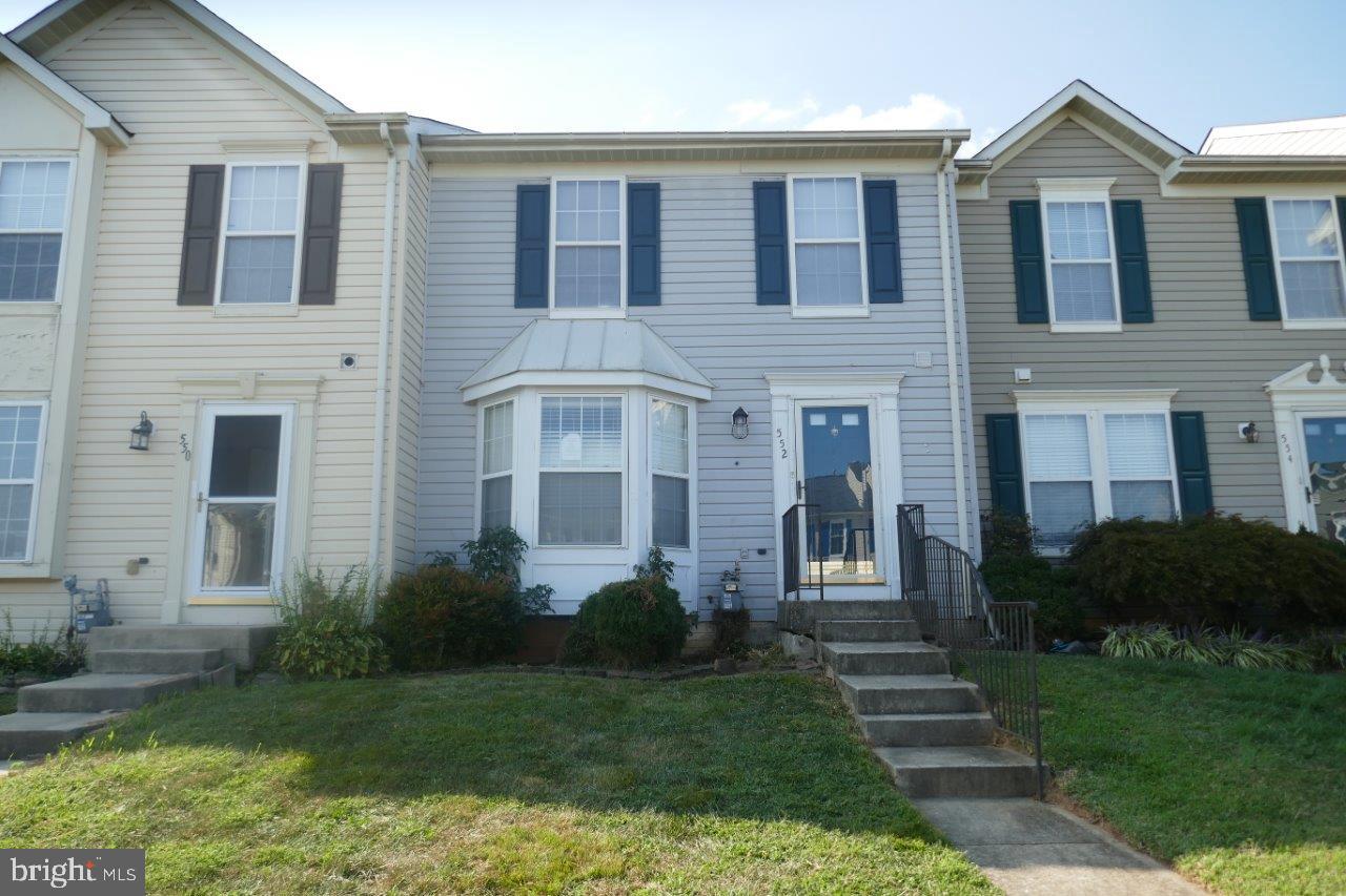 a front view of a house with garden and porch