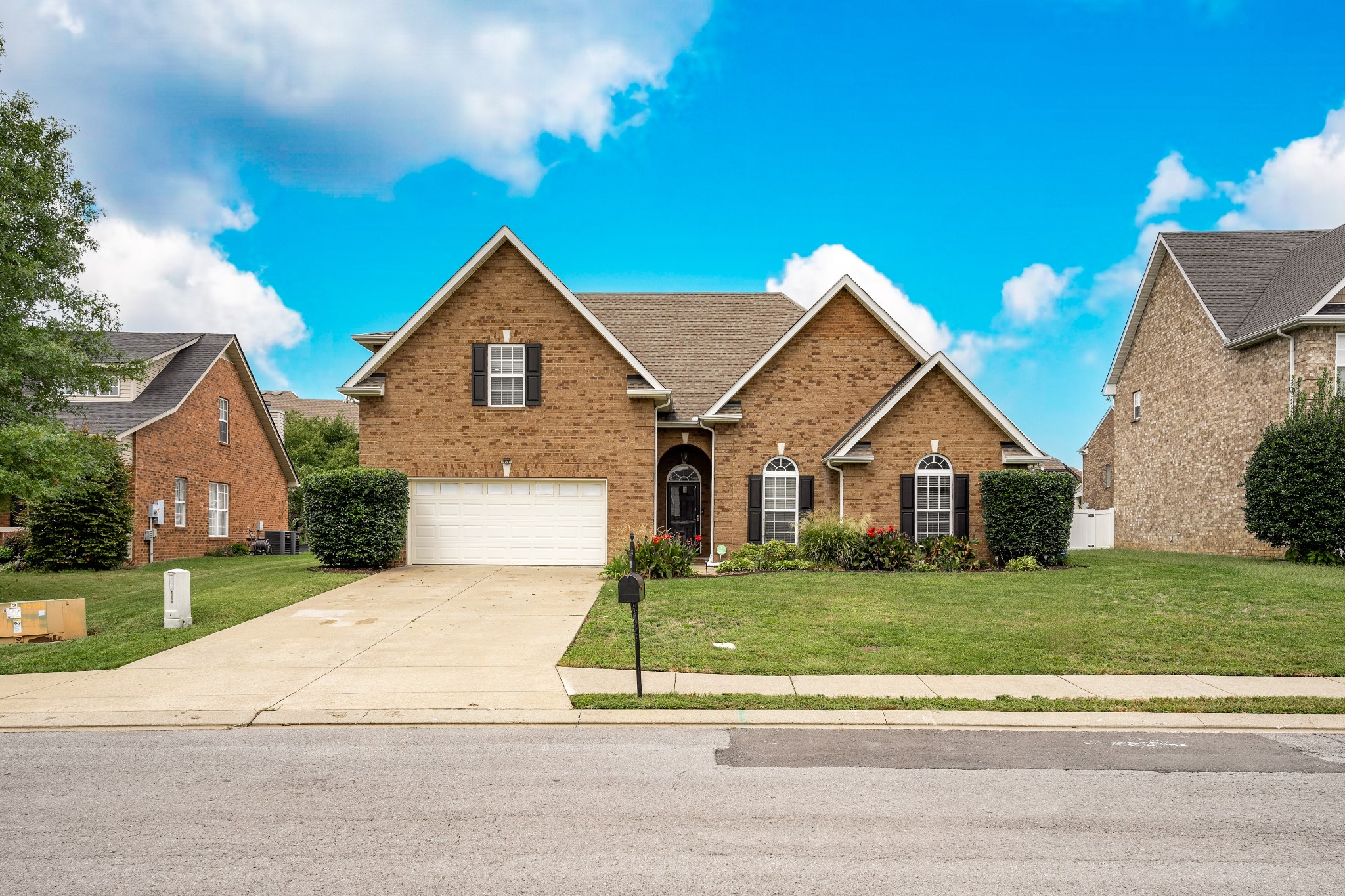 a front view of a house with a yard