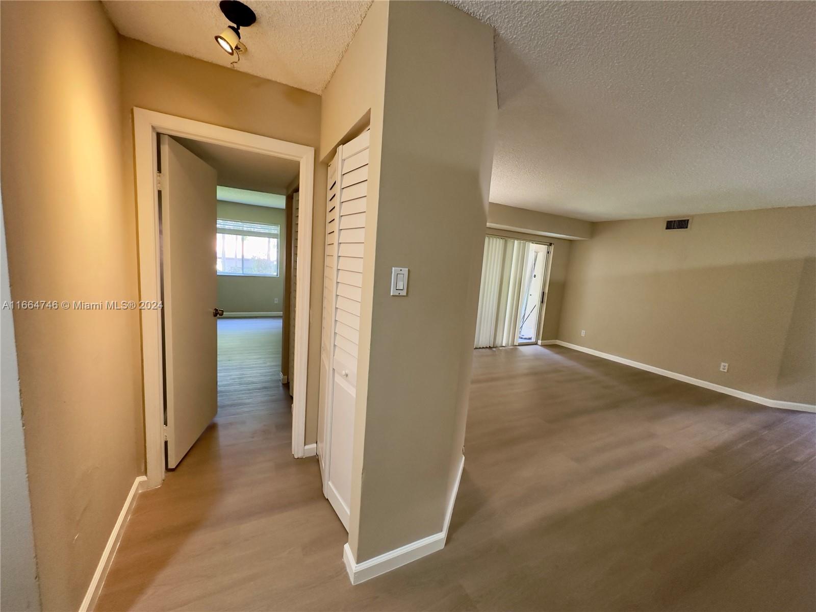 wooden floor in a hall with a glass door