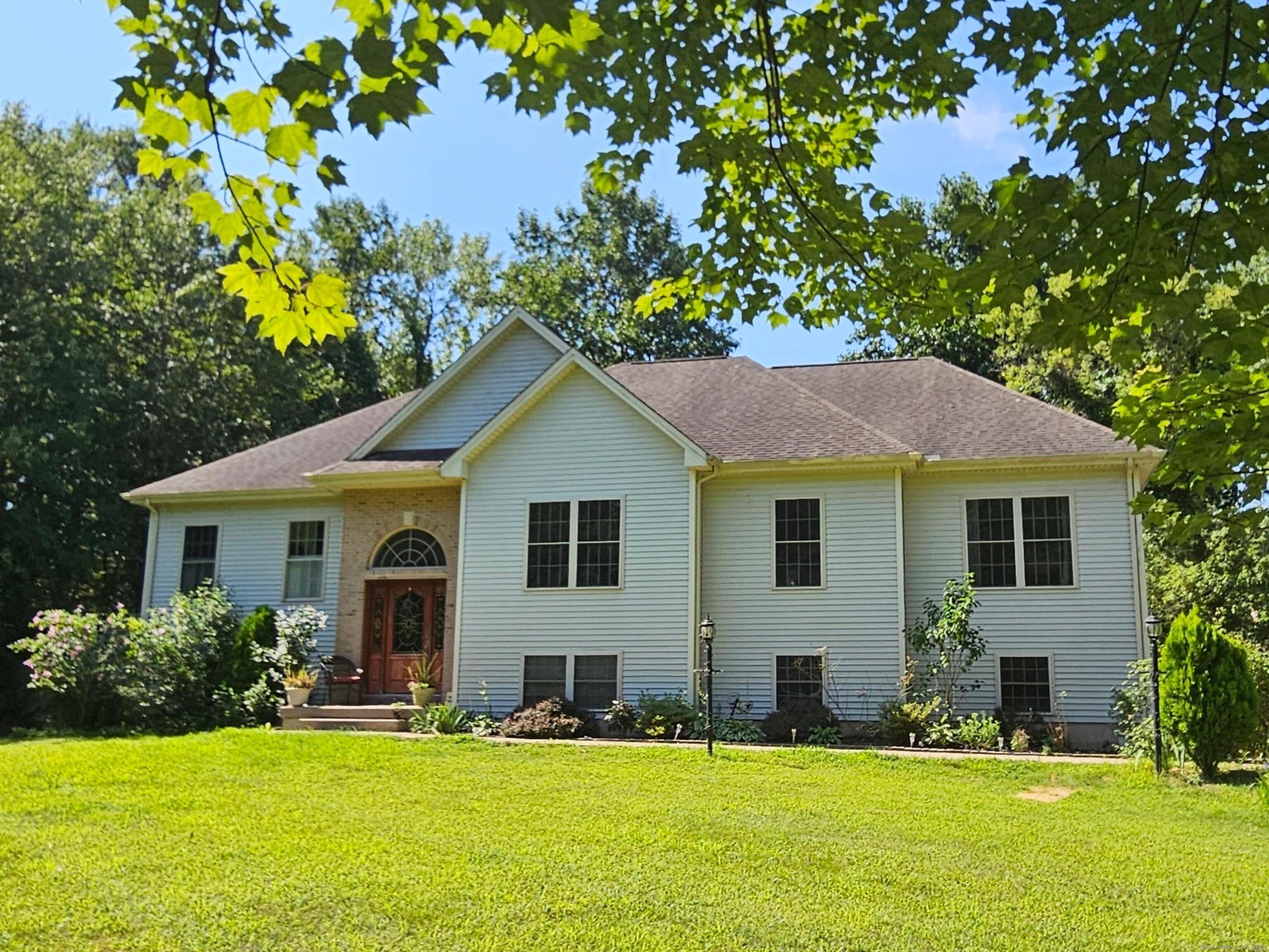 a front view of house with yard and green space