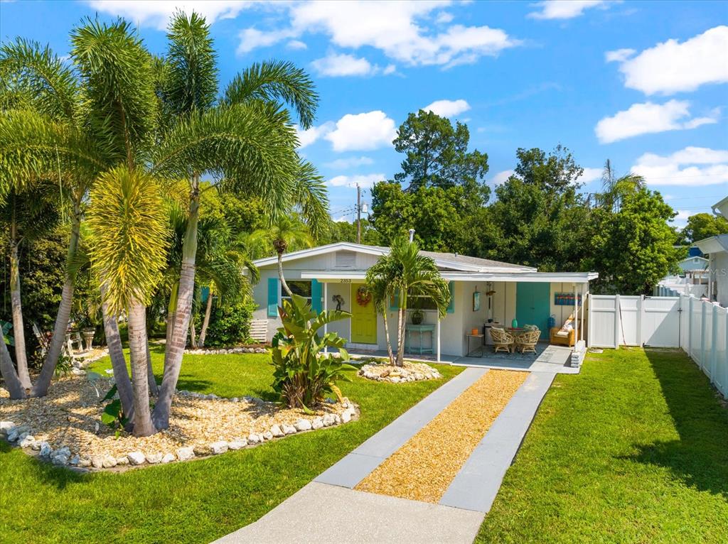 a view of a house with backyard and sitting area