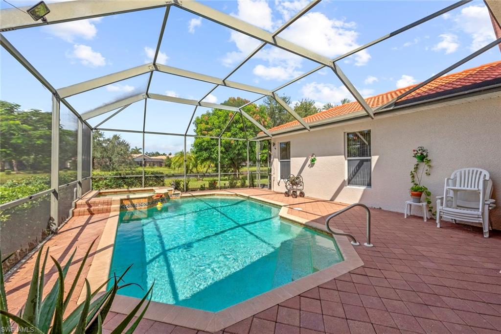 a view of a patio with table and chairs under an umbrella