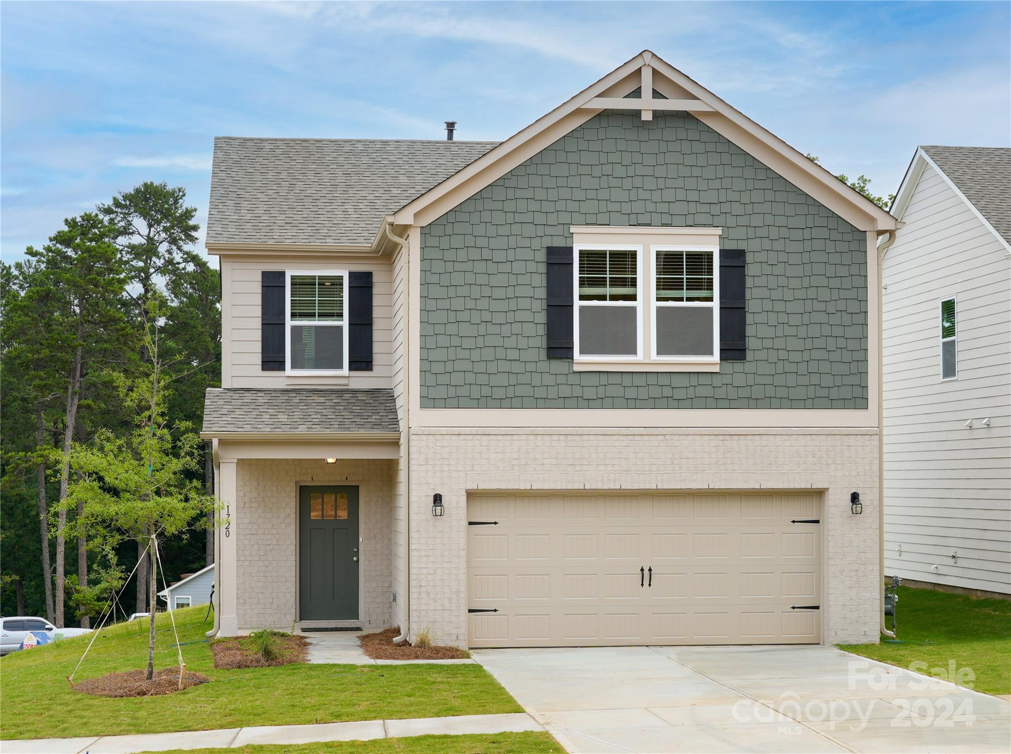 a front view of a house with a yard and garage