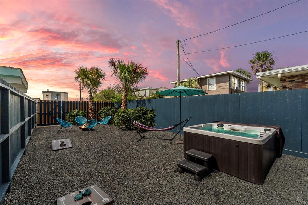 a backyard of a house with table and chairs