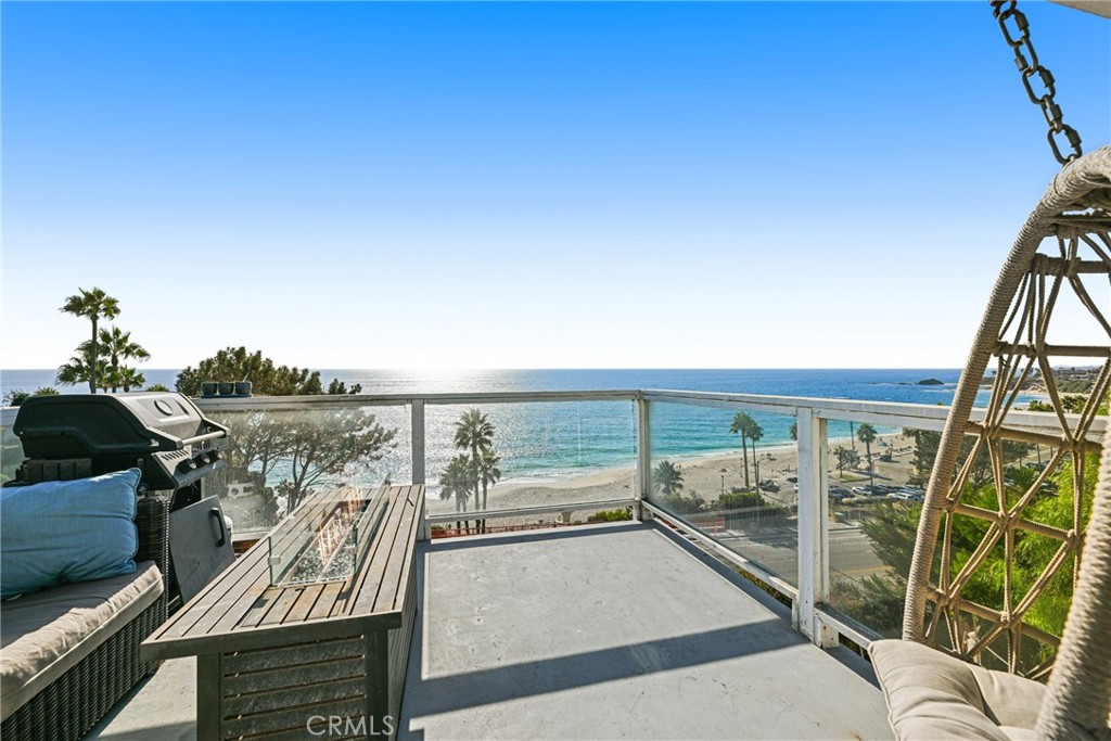 a view of roof deck with furniture and mountain view