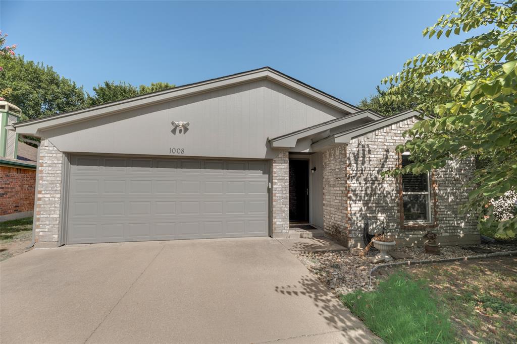 a view of a house with a yard and garage