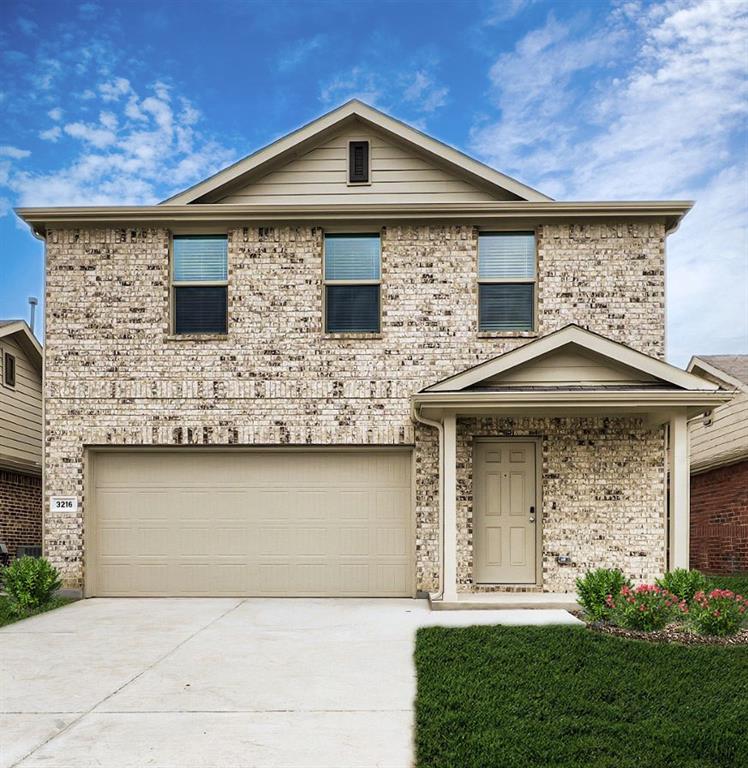 a front view of a house with garage