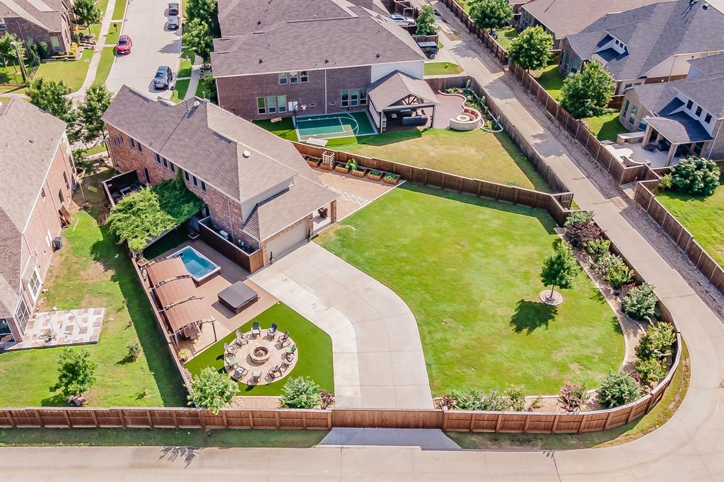 an aerial view of residential houses with outdoor space and swimming pool