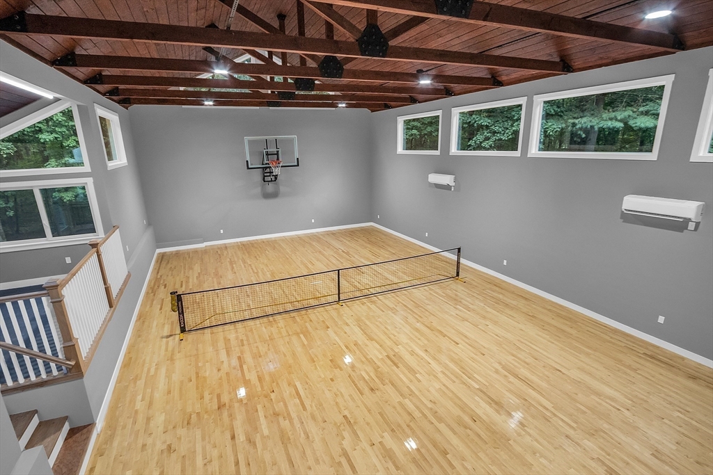 a view of a room with wooden floor and windows