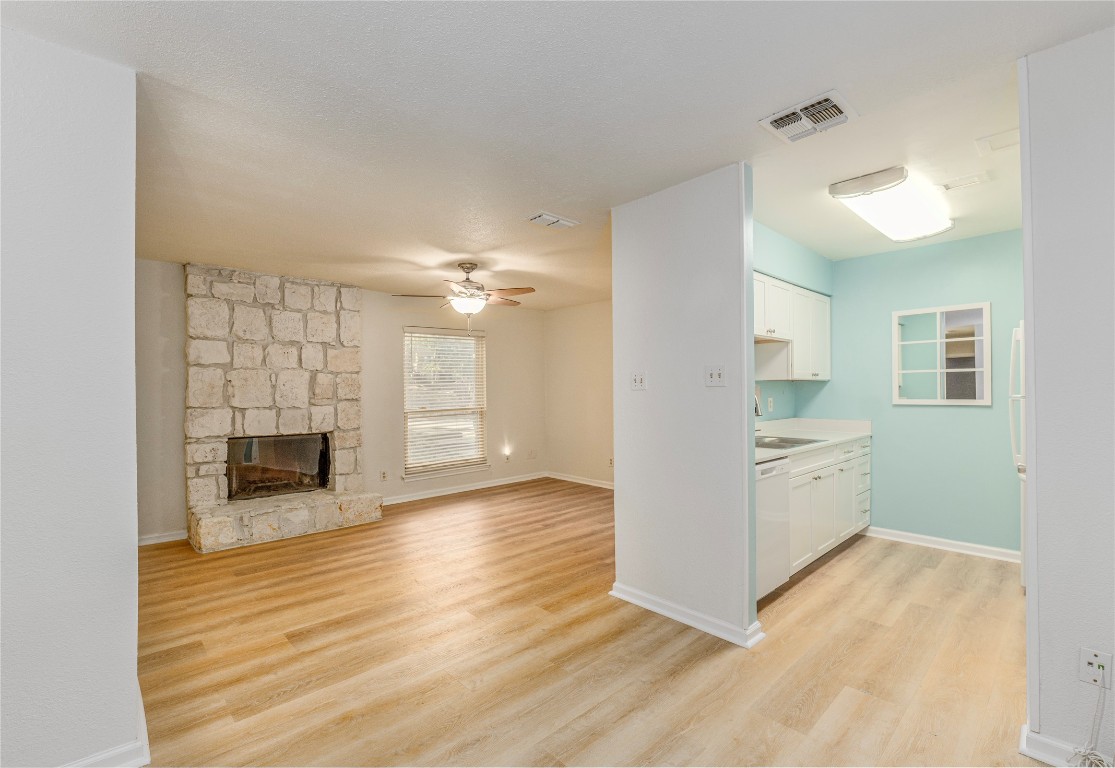 a view of a kitchen with a sink and a fireplace