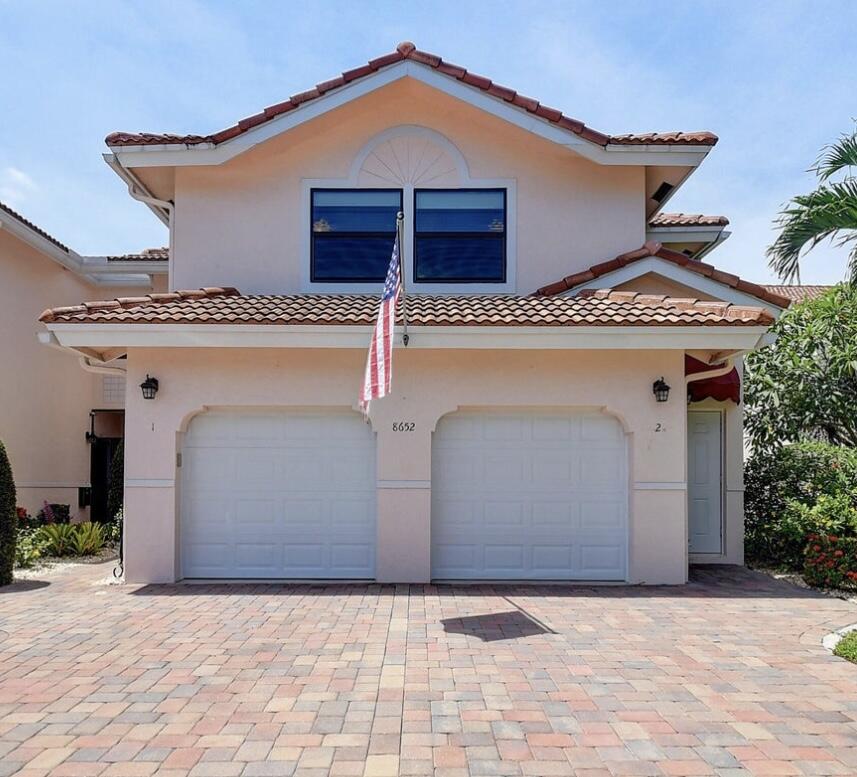 a front view of a house with garage