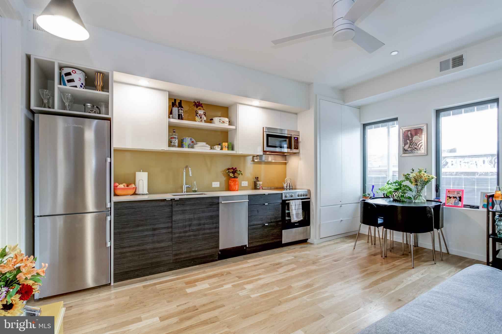 a kitchen with stainless steel appliances granite countertop a refrigerator and a sink