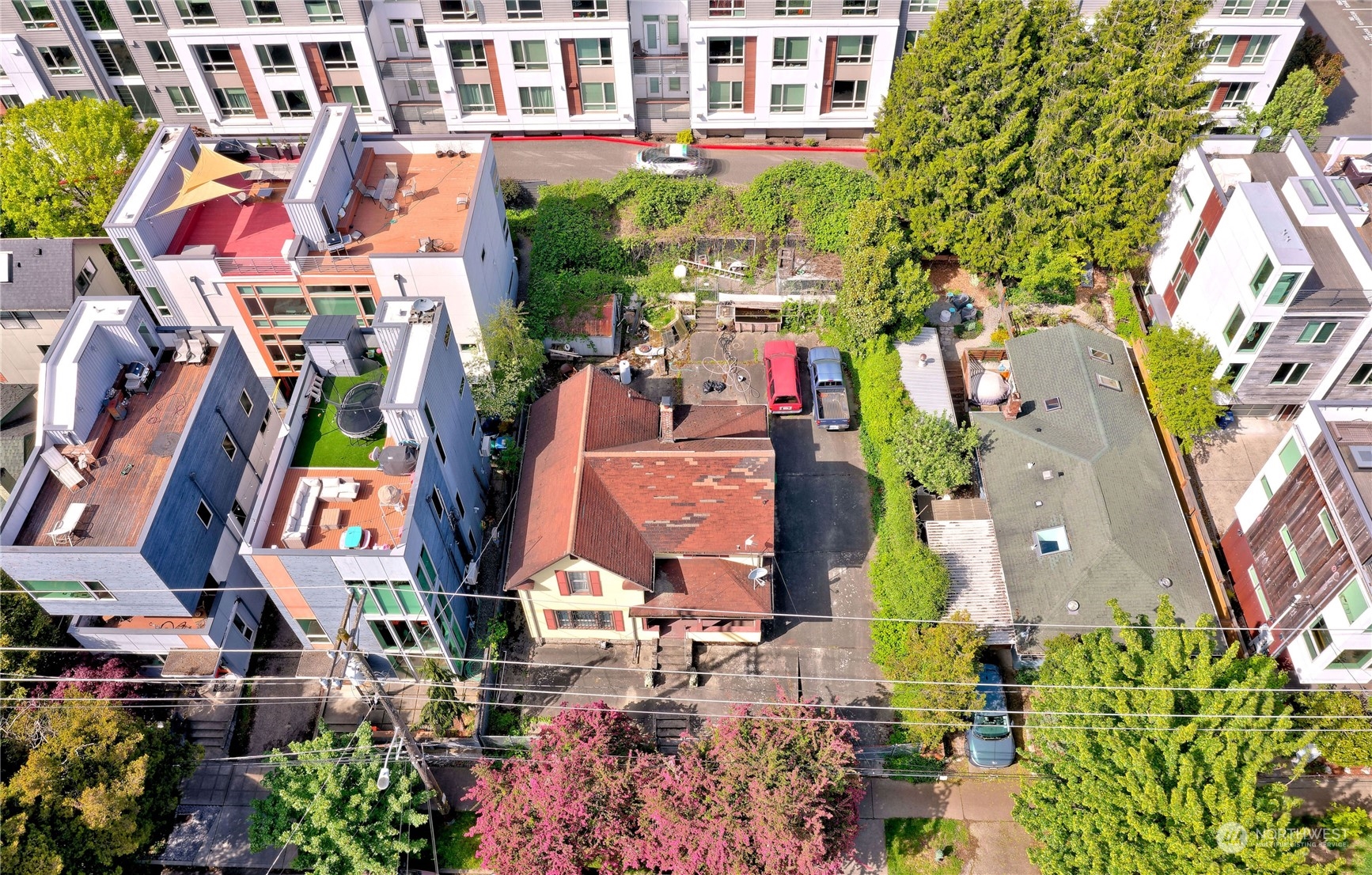 an aerial view of multi story residential apartment building with yard and outdoor seating