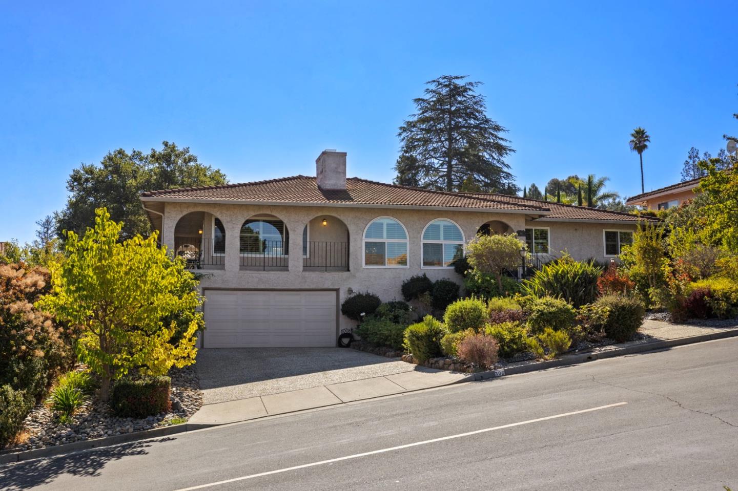 a front view of a house with a garden