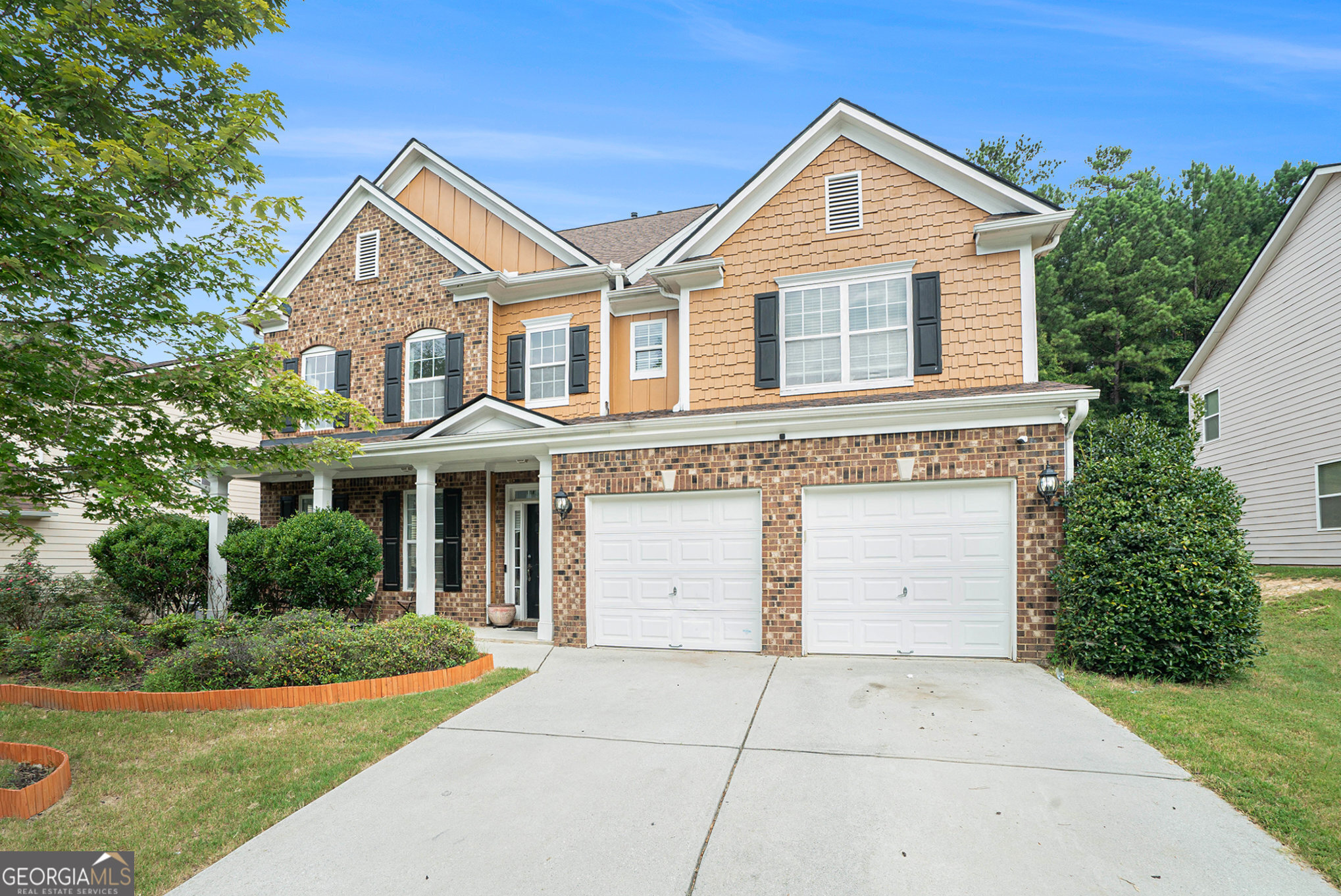 a front view of a house with a yard and garage