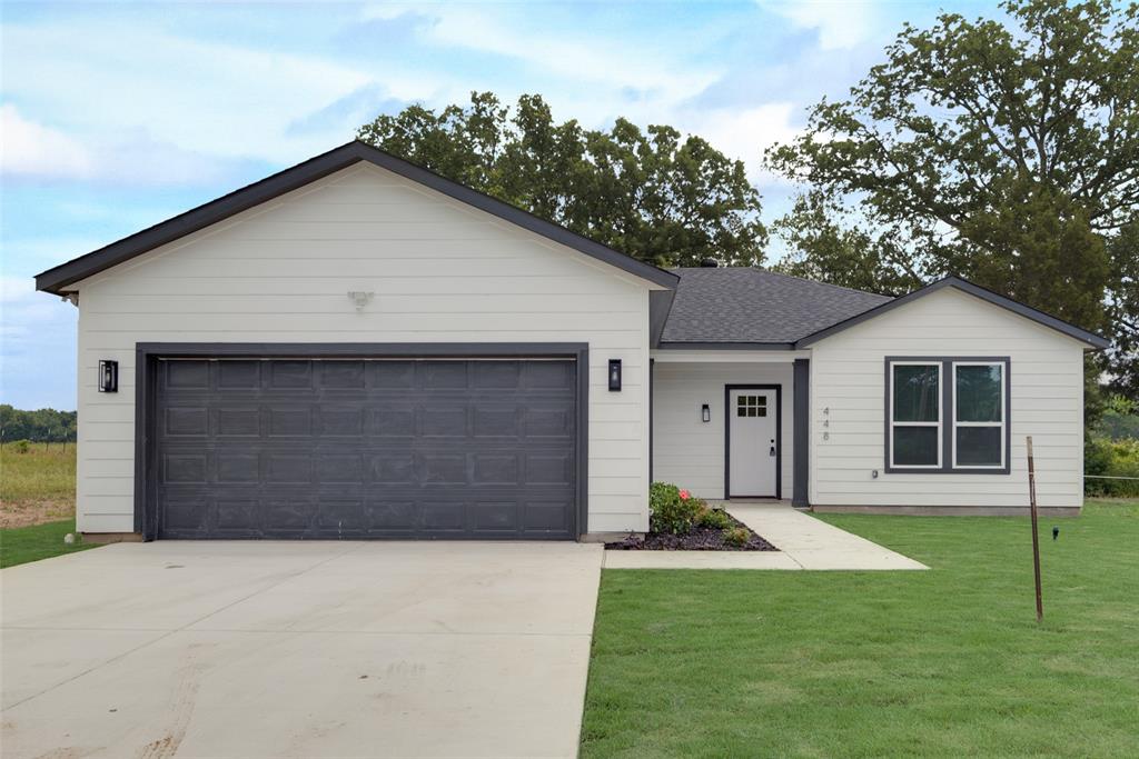 a front view of a house with a yard and garage