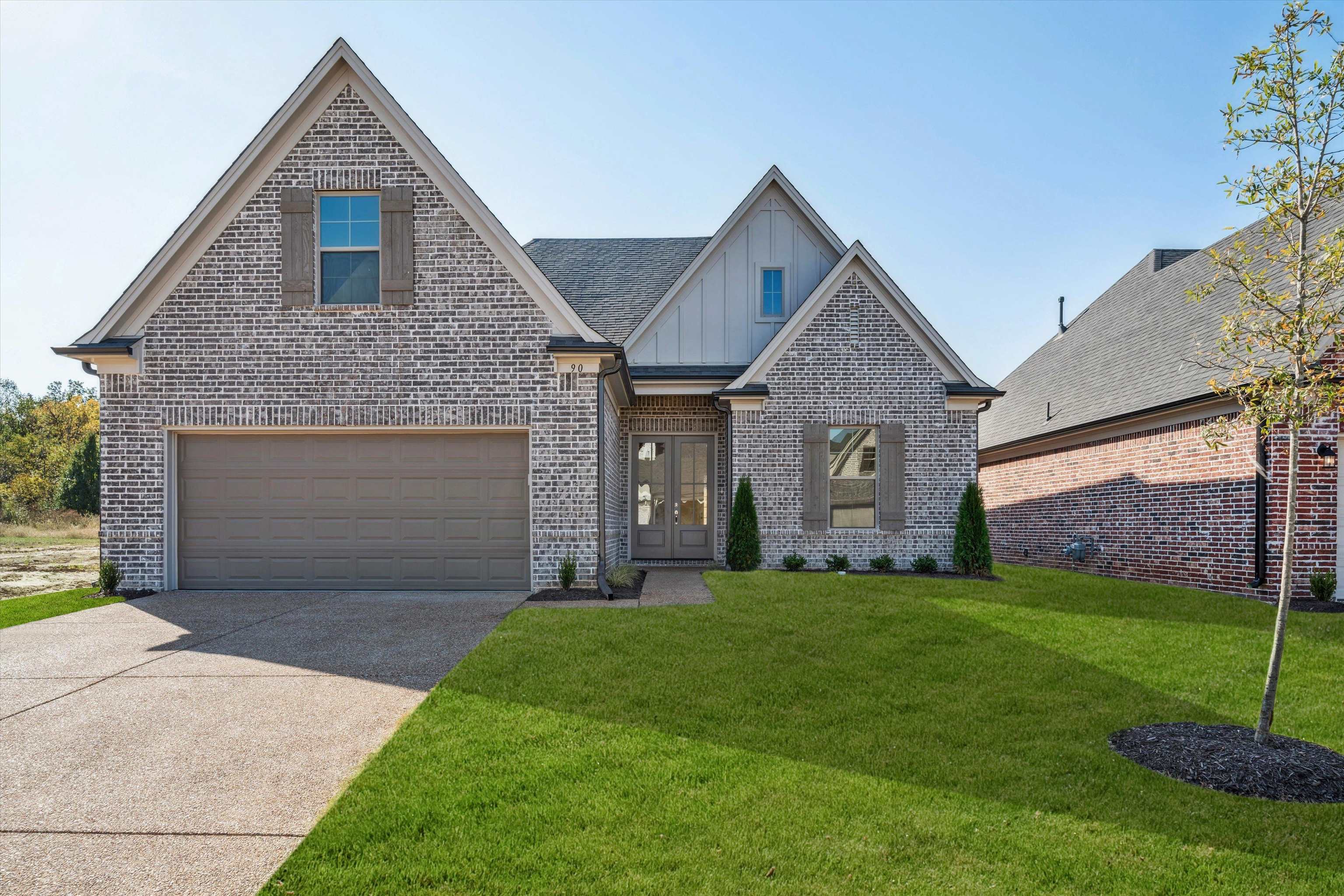 a front view of a house with a yard