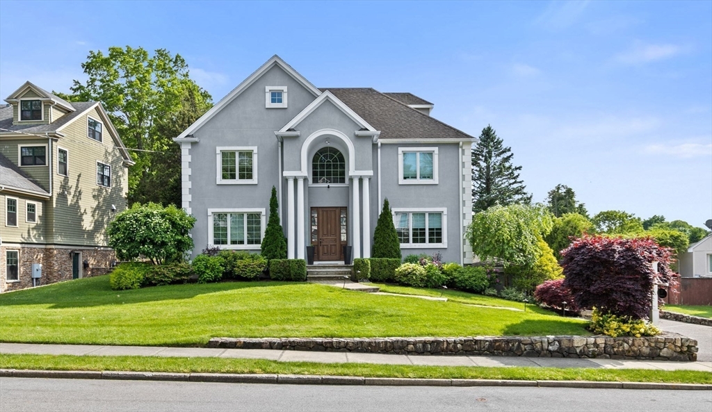 a front view of a house with a yard