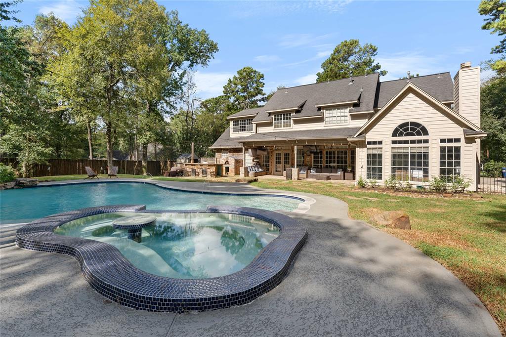 a view of a house with swimming pool and sitting area