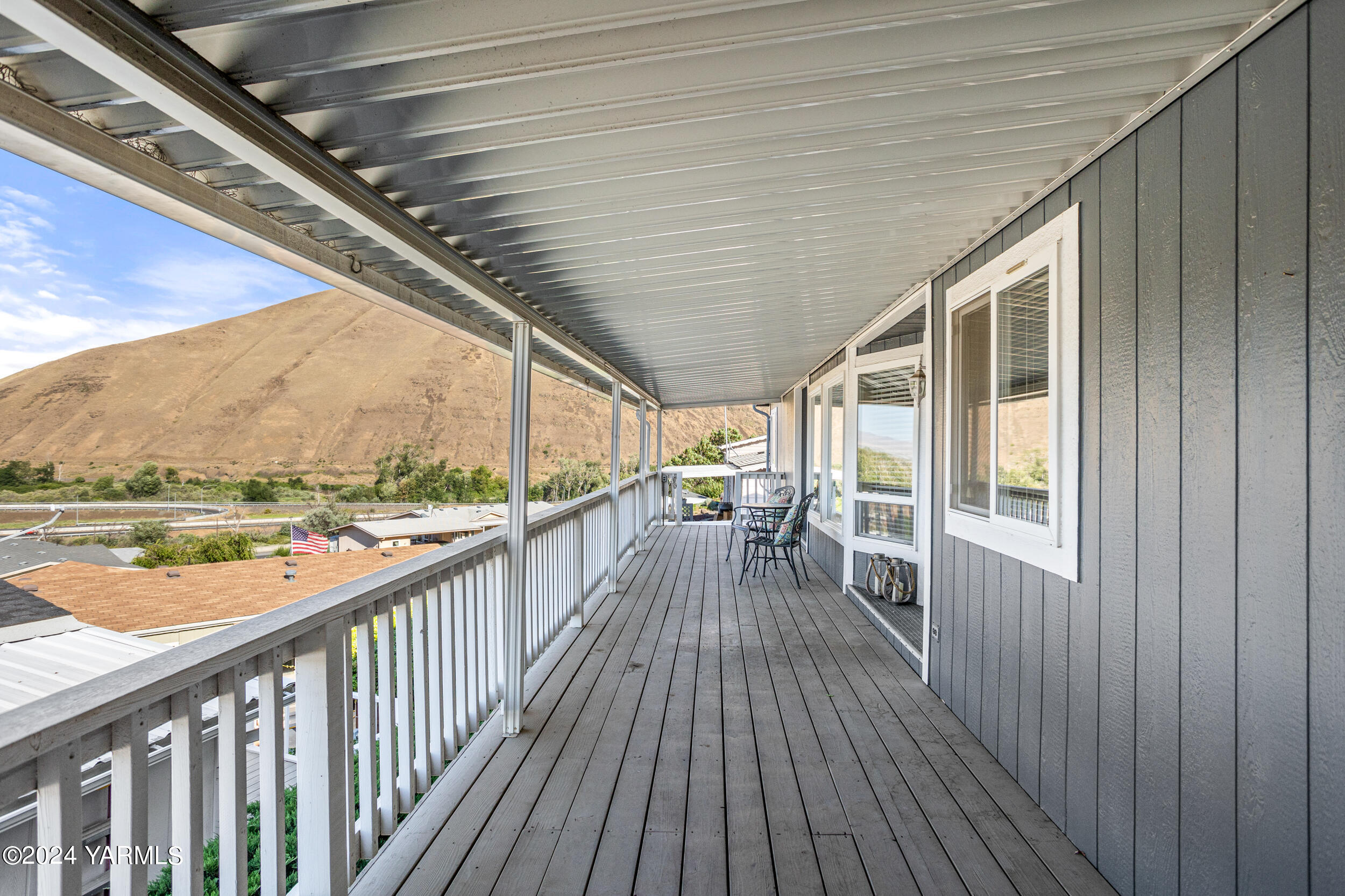 a view of a balcony with wooden floor