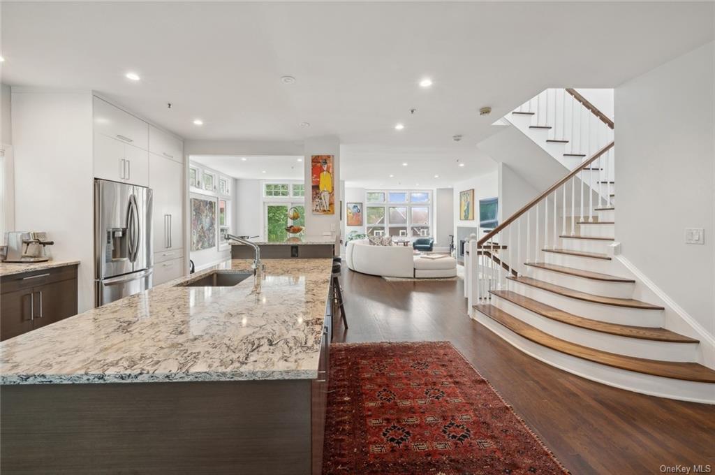 a living room with dining room and wooden floor