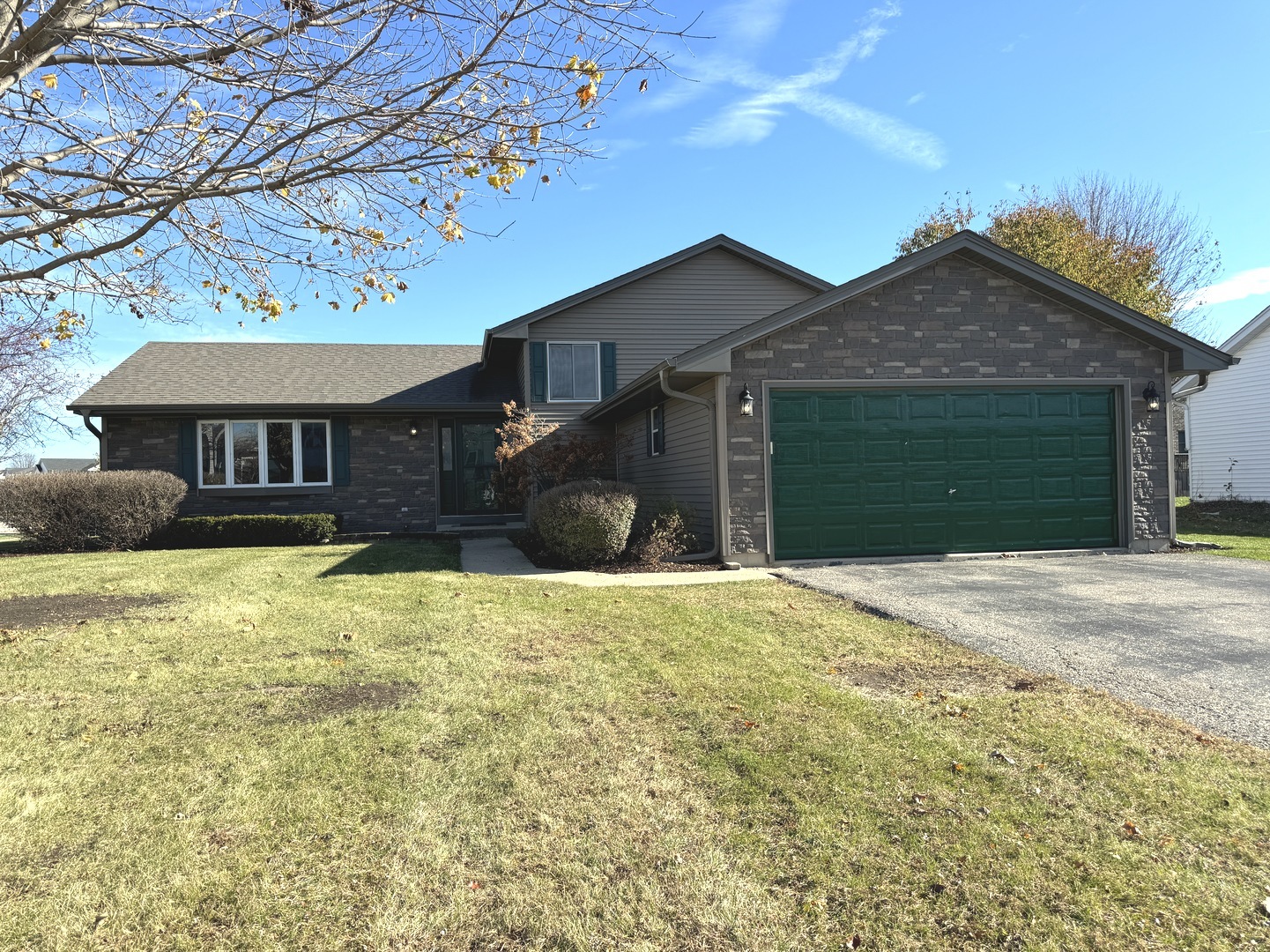 a front view of a house with a yard and garage