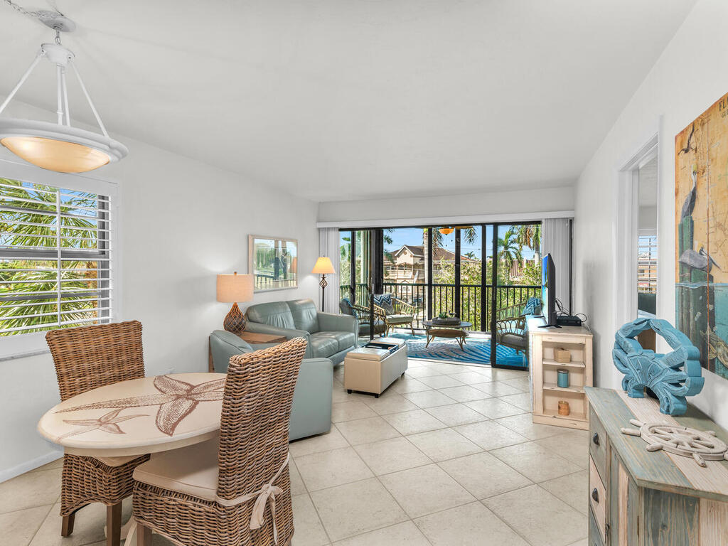 a living room with furniture and floor to ceiling windows