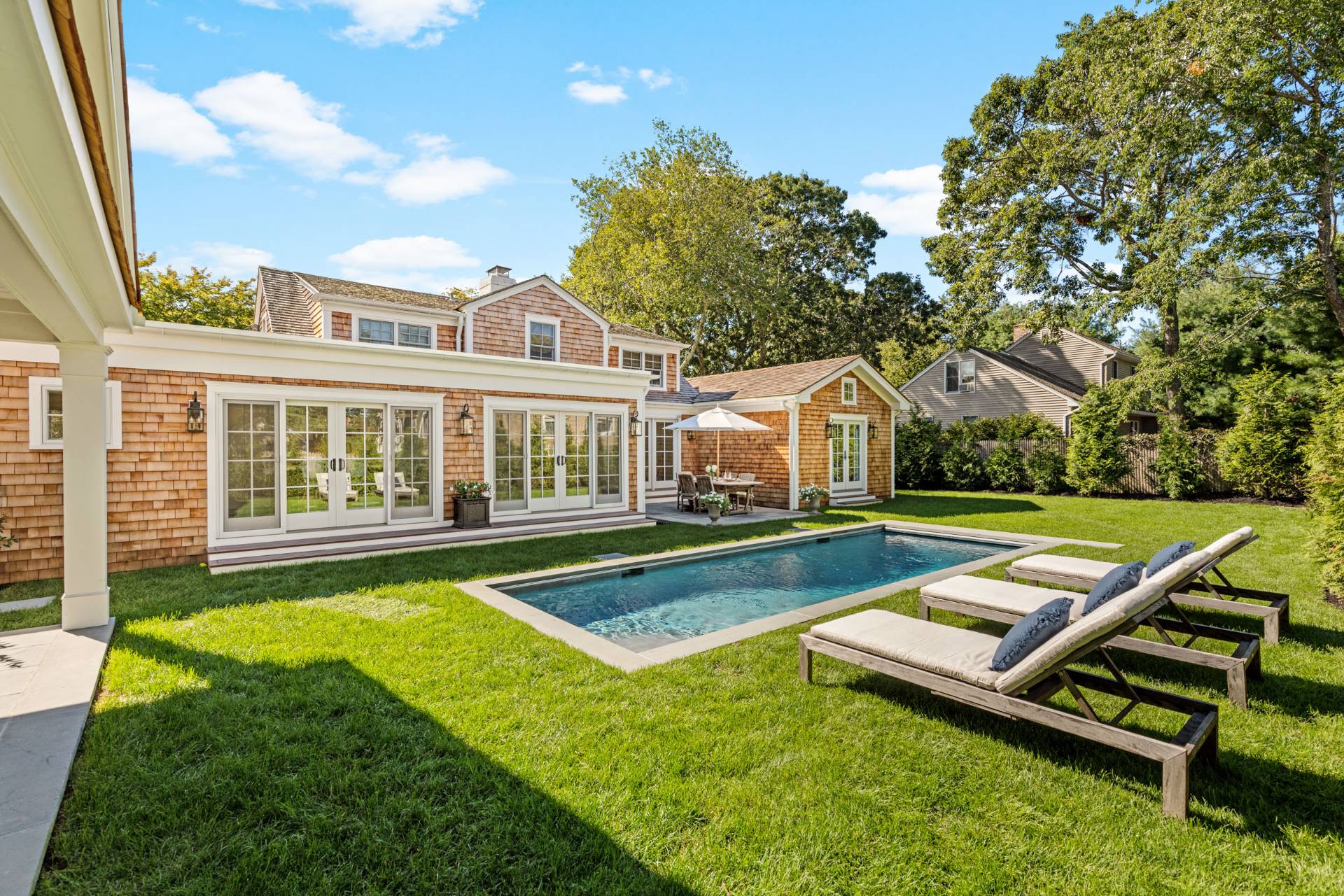 a view of a house with swimming pool and a yard