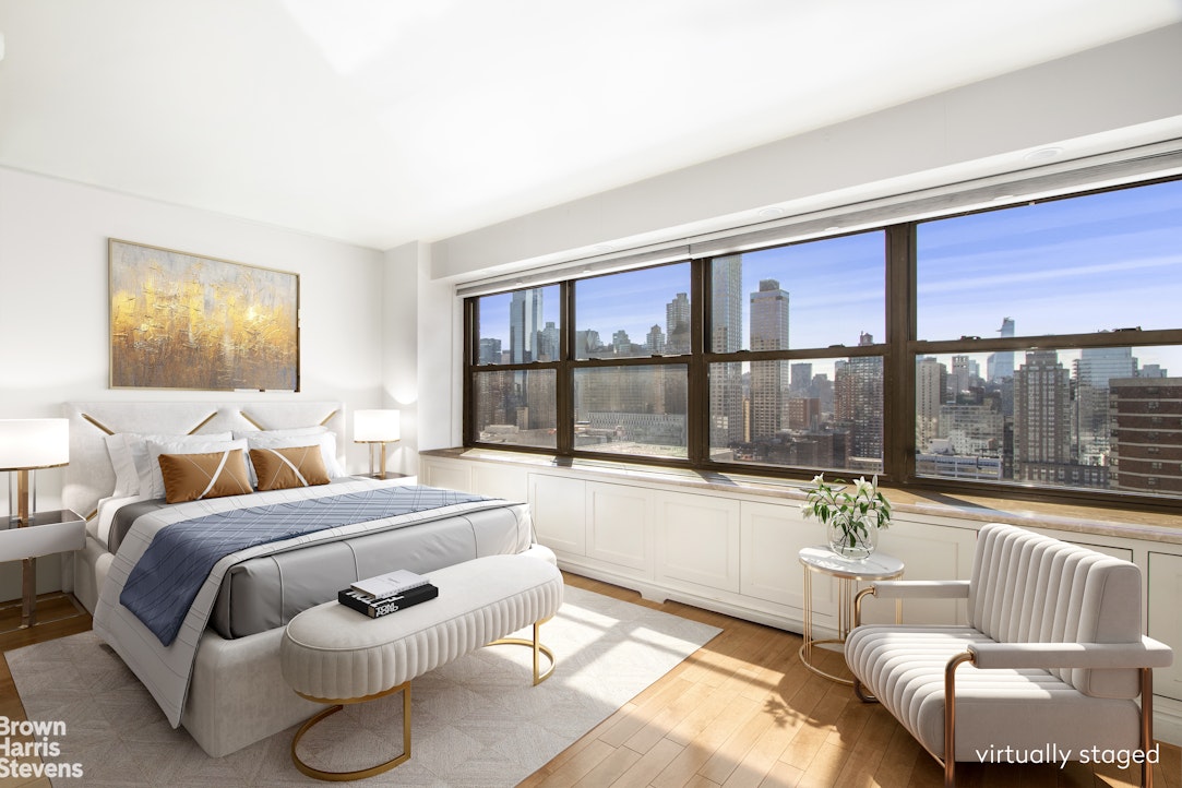 a bedroom with furniture and a large window