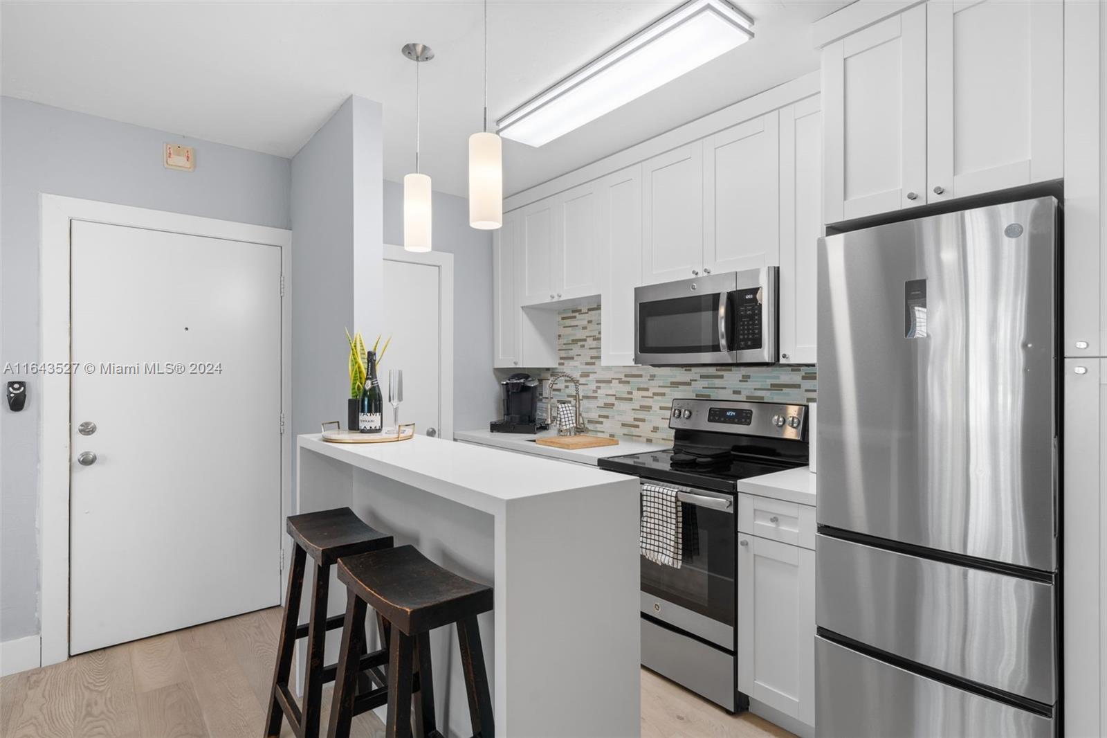 a kitchen with stainless steel appliances a refrigerator stove and microwave