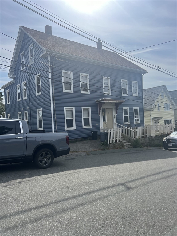 a front view of a residential apartment building with a yard