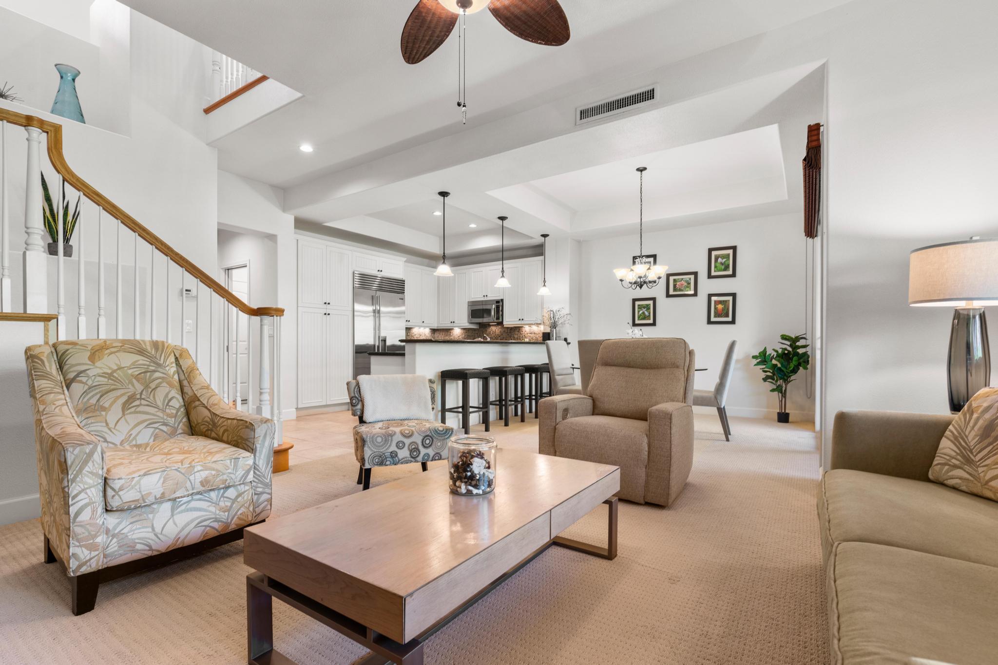 a living room with furniture and kitchen view