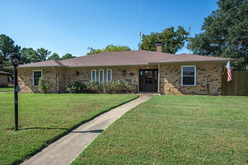 a view of a house with yard and a garden